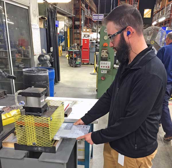 Worker producing face mask protection screen for COVID-19