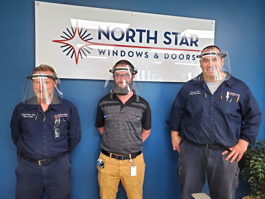 Team members wearing PPE visors